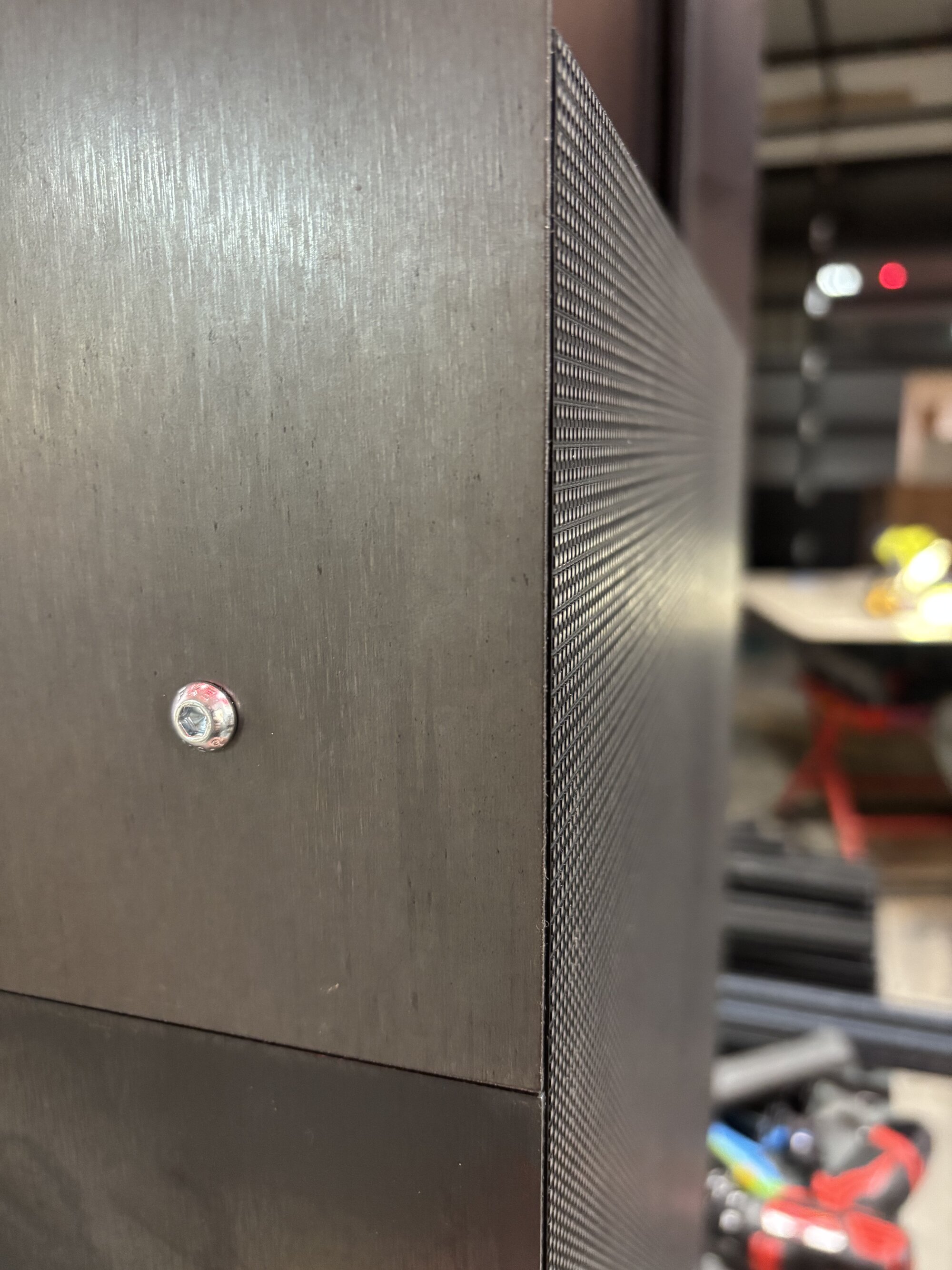 On-site installation — a finished steel screen panel mounted and aligned in place
